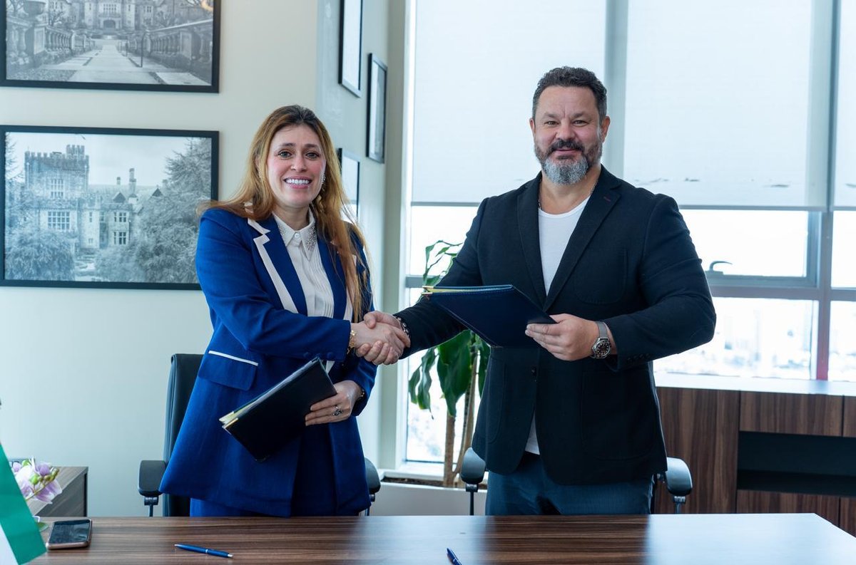 MoU signing handshake — BARZ Solutions FZE and Royal Roads University